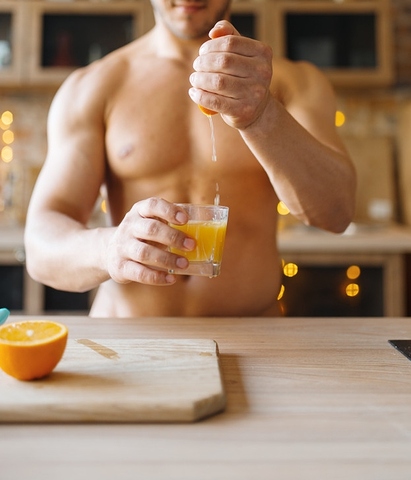 muscular-man-with-naked-body-cooking-orange-juice-on-the-kitchen-nude-male-person-preparing-breakfast-at-home-food-preparation-without-clothes_266732-5816(1)